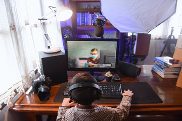 Little asian boy using pc computer to studying . selected focus on one eye with blurred background,vintage style