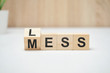 Less mess words on wooden blocks.