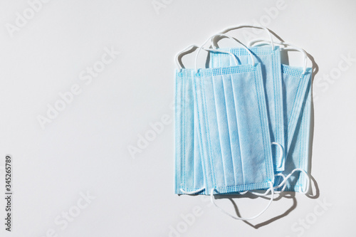 Cuadros en Lienzo Stack of facial medical masks, white background, close up