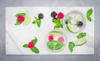 Wall Mural - infused water with blackberry ,raspberry ,mint and lime on grey background