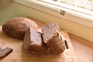 A fresh crusty loaf of homemade bread. Homemade rustic sour bread on a wooden chopping board.
Slice of brown bread. Sliced bread. 