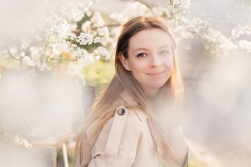 Closeness to nature. happy beautiful girl in blooming gardens. Natural beauty