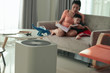 air purifier in living room with mother and kid reading inside home