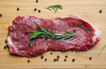 steak, rosemary and salt on a serving board