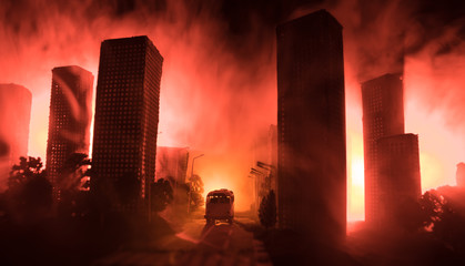 Empty street of burnt up city, flames on the ground and blasts with smoke in the distance. Apocalyptic view of city downtown as disaster film poster concept. Night scene. City destroyed by war.