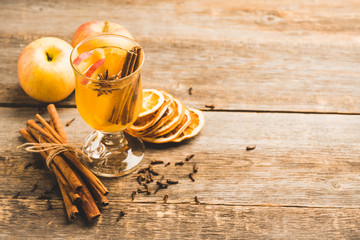 Healthy hot beverage with oranges, apples and spices for protection in flu season. Selective focus. Shallow depth of field.