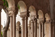 The decorative columns with human and animal like figures and arches of the corridors of the 13th Century Franciscan Monastery cloister in the Old Town of Dubrovnik, Dalmatia, Croatia in summer