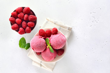 Wall Mural - Ice cream scoop in bowl and fresh raspberries