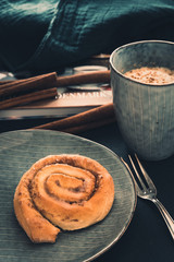 Wall Mural - Homemade cinnamon roll and coffee in cozy home environment