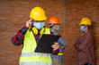 © visoot - Engineer women wear protective face masks for safety at construction site,Coronavirus has turned into a global emergency.