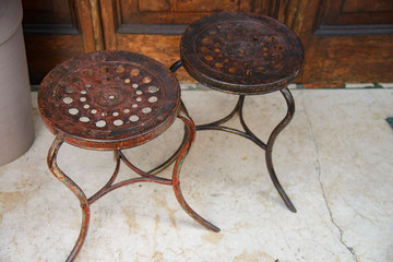 Vintage pair of old wrought iron stools.