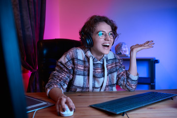 Aufkleber - Smiling young freelancer working from home sitting in a cosy chair at the desk with computer.