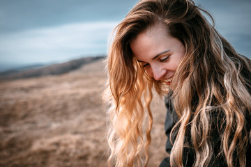 Wall Mural - Happy young woman with long hair lifestyle portrait outdoor