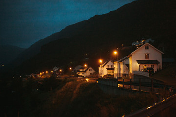 night landscape of houses lit by yellow lanterns in norway