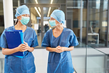 Wall Mural - Two surgeons in blue surgical gown with surgical mask