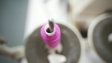 Spool Of Purple Thread On A Sewing Machine