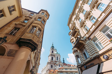 view of the church between two houses in Prague