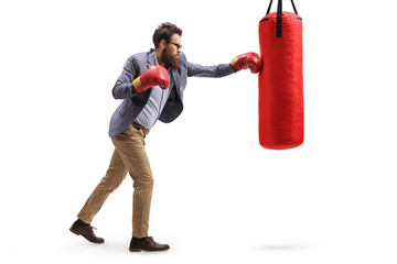 Canvas Print - Man in formal clothes punching a boxing bag