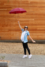 Pregnant Woman In Full Height Holds An Umbrella