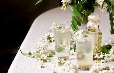 Sticker - acacia flowers drink. lemonade with a syrup of white acacia flowers. Edible flowers.