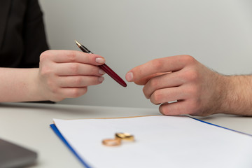 Wall Mural - Prenuptial agreement concept. Man and woman signing notary document together