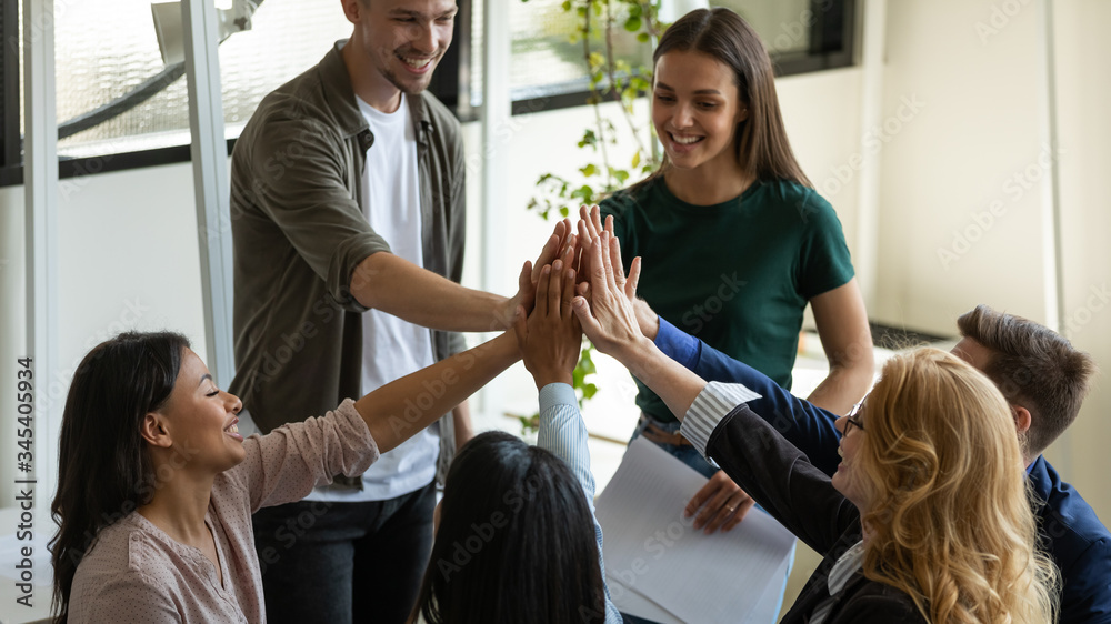 Multiracial workers with female leader, coach giving high five at ...