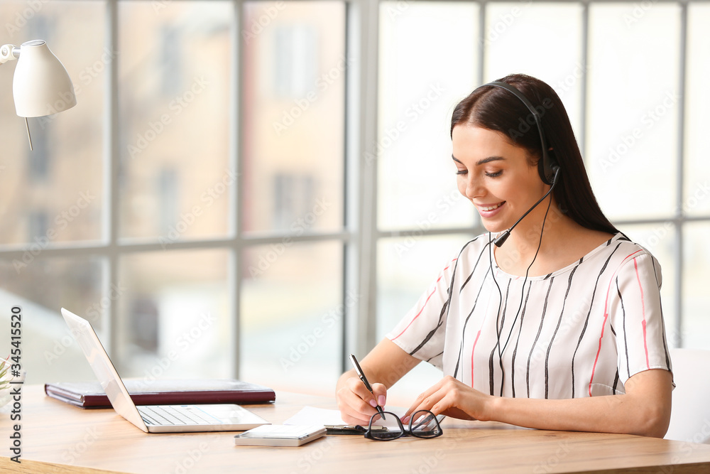 Beautiful young secretary working in office