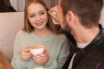 Sticker - Young couple drinking coffee in cafe