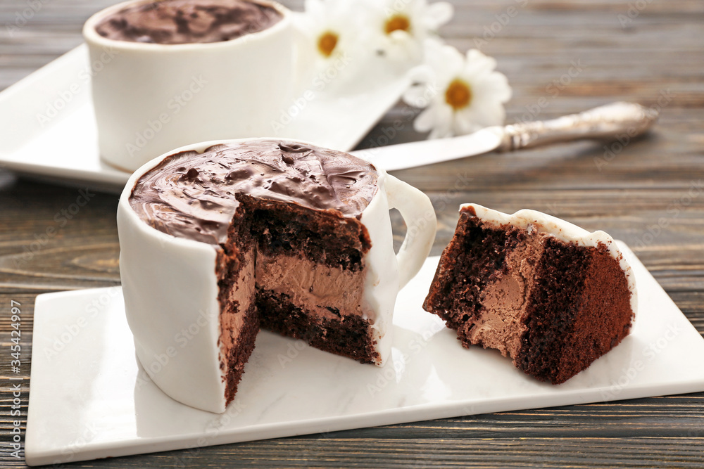 Chocolate cake in shape of coffee cup on table