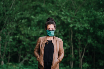 photo of woman in the forest with face mask