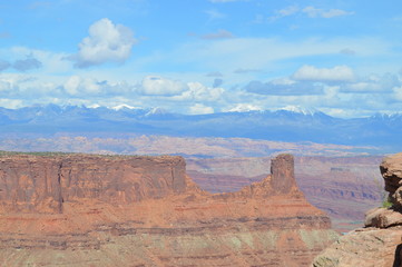 Rock formations at Dead Horse Point with Potash Ponds and the snowcapped La Sal Mountain range in the distance, Utah