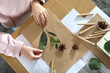 Little girl working with natural materials at table, top view. Creative hobby