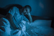 © TheVisualsYouNeed - dramatic portrait in the dark of attractive depressed and worried man on bed suffering depression crisis and anxiety feeling lost lying sleepless in insomnia and life problem concept