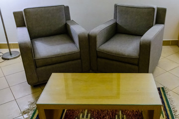 two armchairs and table in a modern room