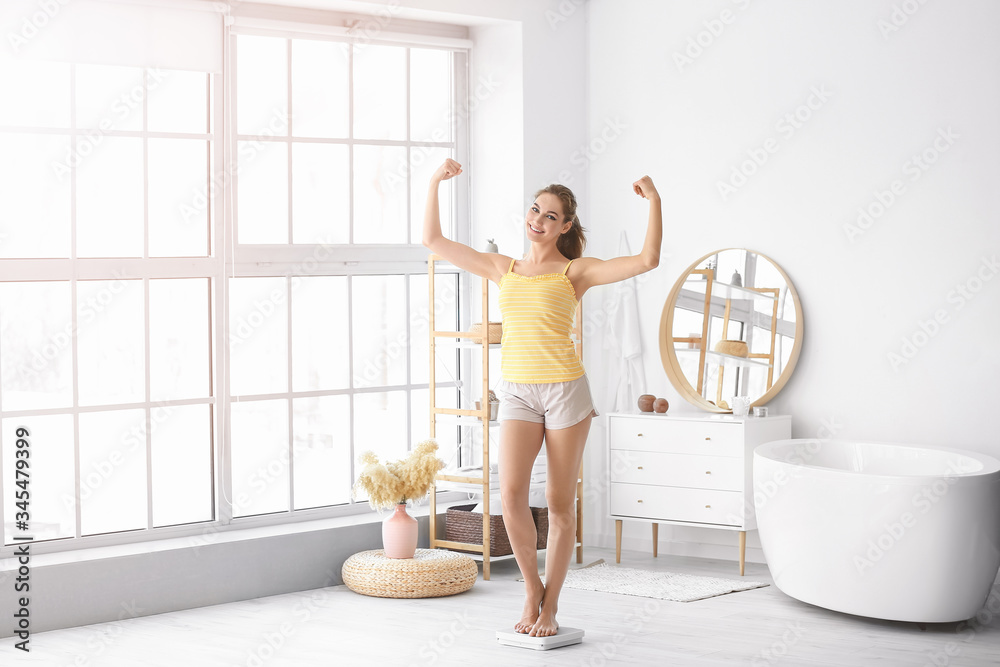 Young woman measuring her weight at home