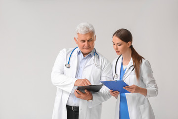 Canvas Print - Portrait of doctors on grey background