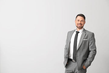 Portrait of handsome businessman on light background