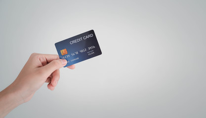 woman's hand holding the credit card for shopping online.