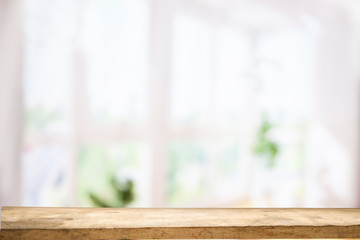 Top of wooden table on window glass blur. Of green from the garden of the vegetable garden on a morning background. To display product montage.