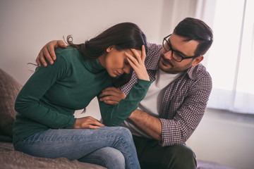 Wall Mural - Woman is sad and depressed, her man is consoling her.