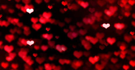 Wall Mural - Red bokeh hearts on black background, blurred, love, bright, Valentine's day, romance