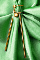 Poster - Earrings on green satin