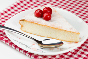 Wall Mural - Piece of cheesecakeon on red-white napkin