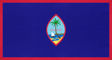 Wall Mural - Guam national fabric flag, textile background. Symbol of unincorporated territory of the United States.