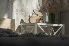 Photo Of A Wooden Rabbit On Wheels Of Beech In Bright Bedroom.