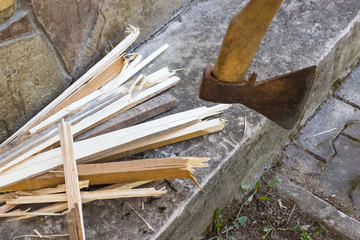 cutting wood. Close-up of axe and chopped firewood at the background. Lumberjack village life away from the city and diseases