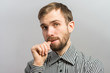 © aeroking - Closeup of thoughtful young man with finger on lips
