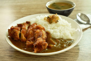 deep fried chicken dressing with Japanese curry on rice topping slice pickled cabbage