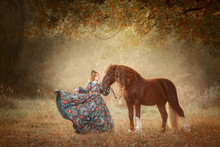 Beautiful Long-haired Blonde Young Woman In National Russian Style With Red Vladimir Draft Horse In Autumn Forest