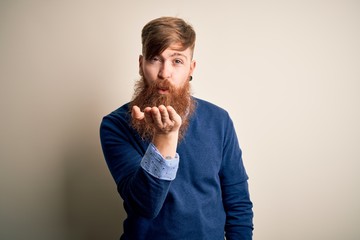 Poster - Handsome Irish redhead business man with beard standing over isolated background looking at the camera blowing a kiss with hand on air being lovely and sexy. Love expression.